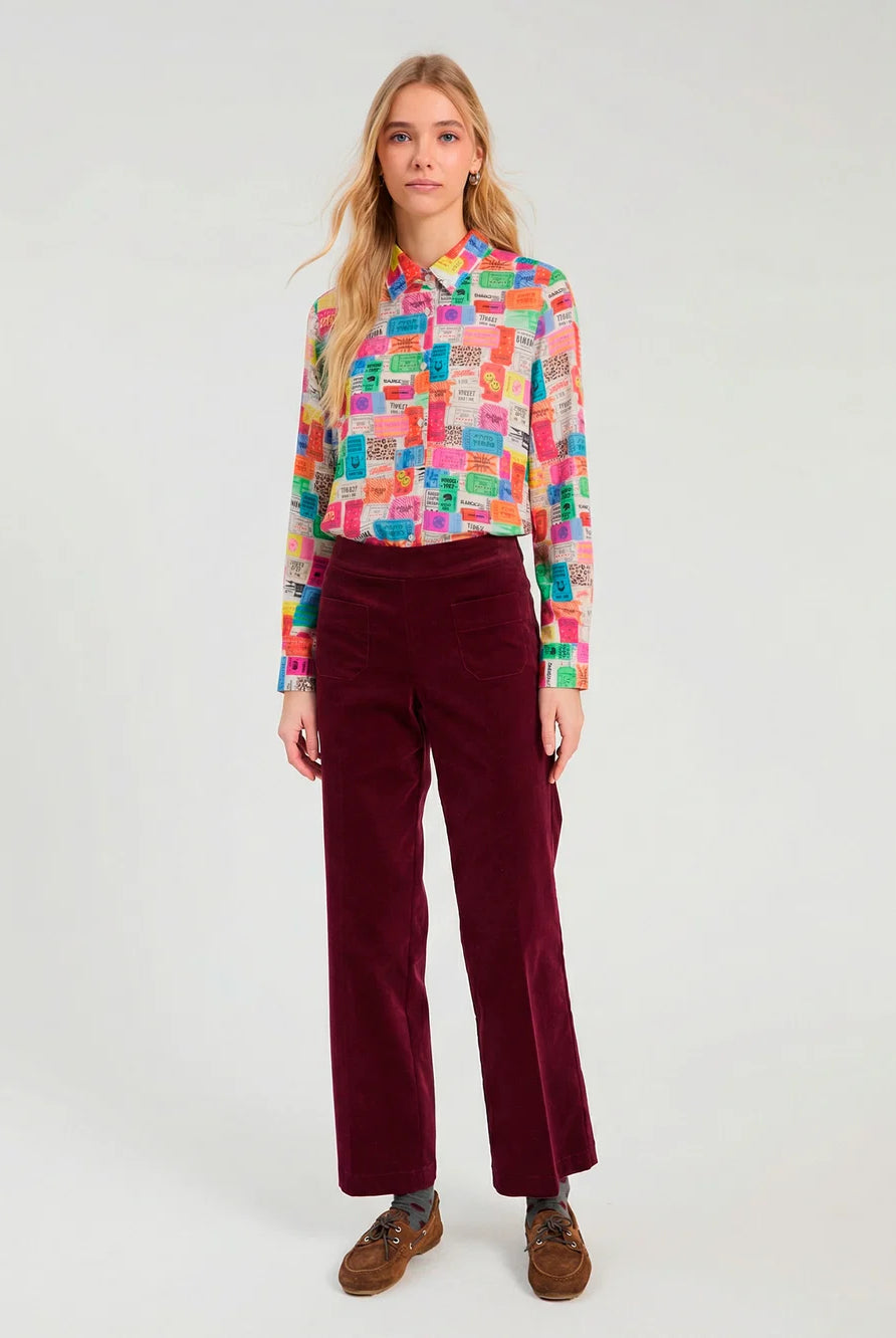 Vilagallo multicolour ticket print long sleeve shirt styled with burgundy trousers