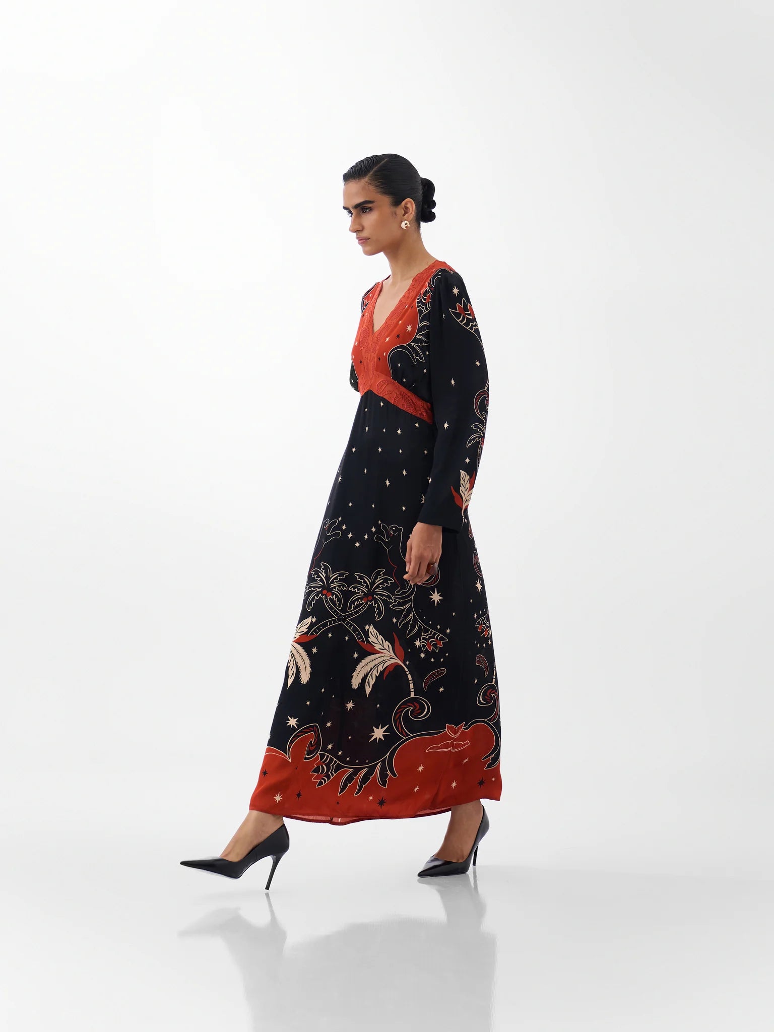NOIB Aura Old Rose printed maxi dress with long sleeves and contrasting orange-red bodice – side model view.