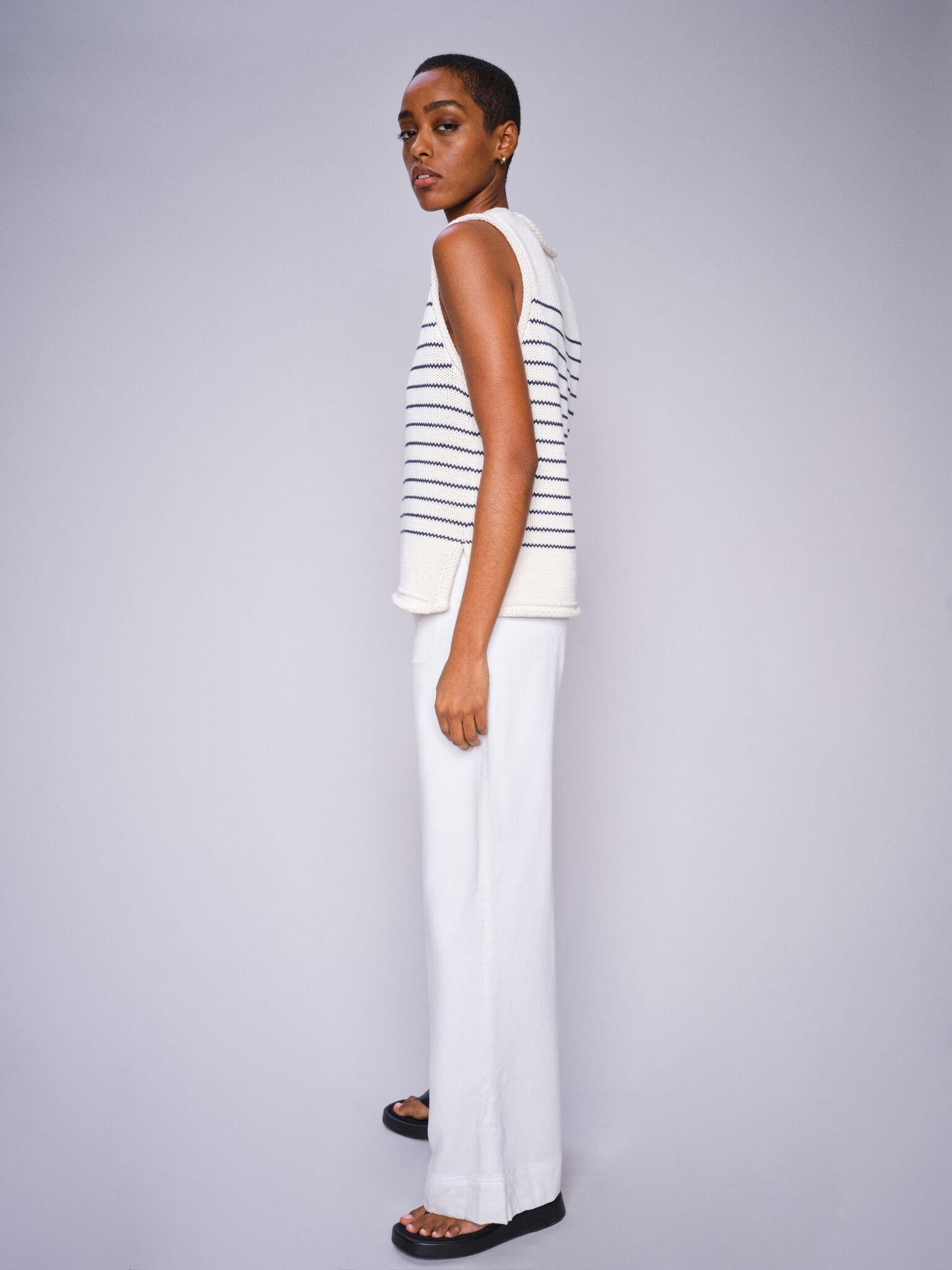 Mos Mosh white wide-leg trousers photographed from the side outdoors