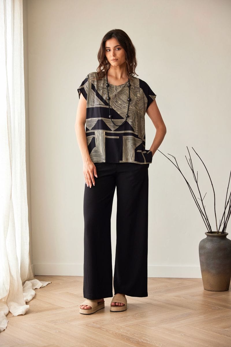 Peruzzi relaxed fit black trousers styled with patterned top full length