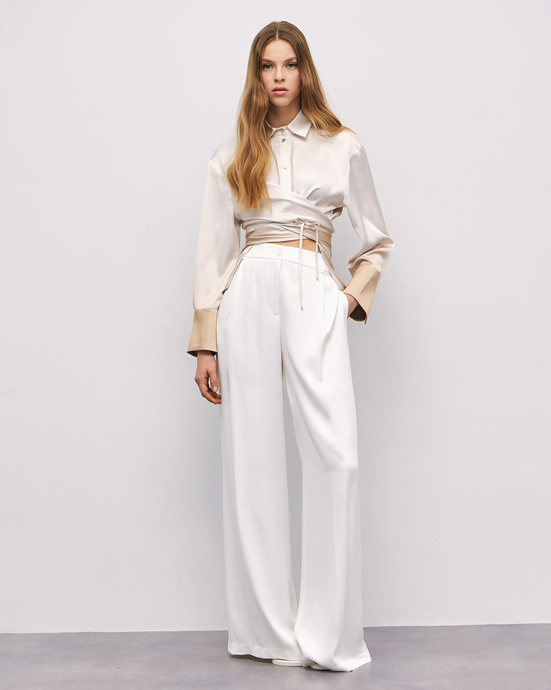 Full-length shot of cream and gold ombré wrap shirt and wide-leg trousers By Access Fashion 