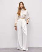 Full-length shot of cream and gold ombré wrap shirt and wide-leg trousers By Access Fashion 