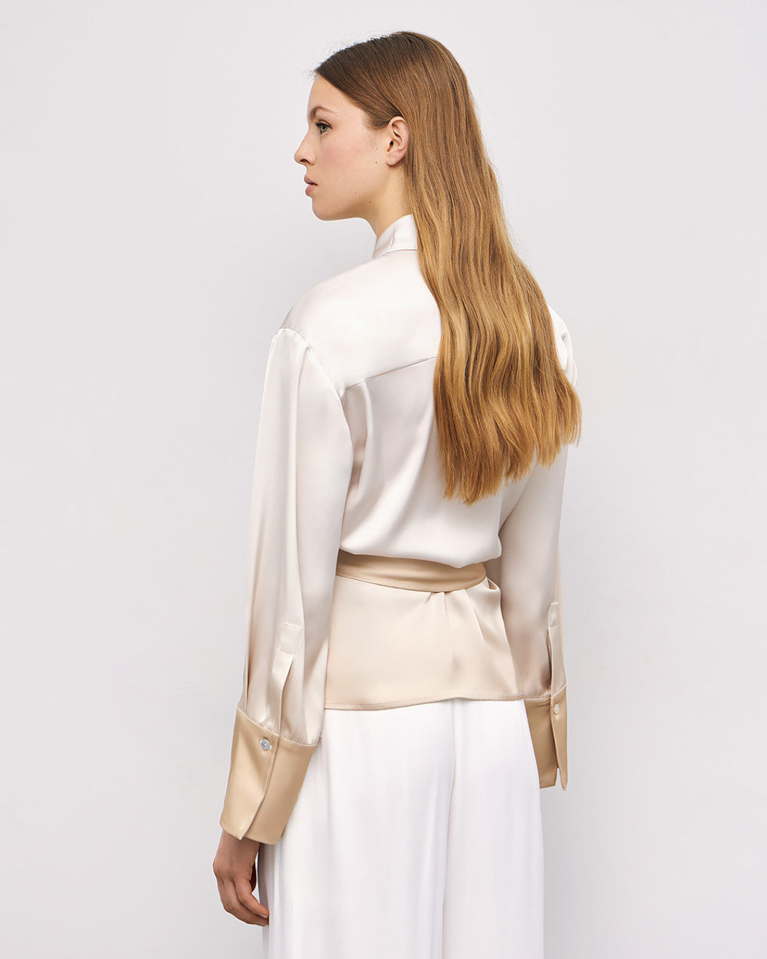 Back view of cream Access Fashion ombré shirt with gold cuffs and wide-leg trousers