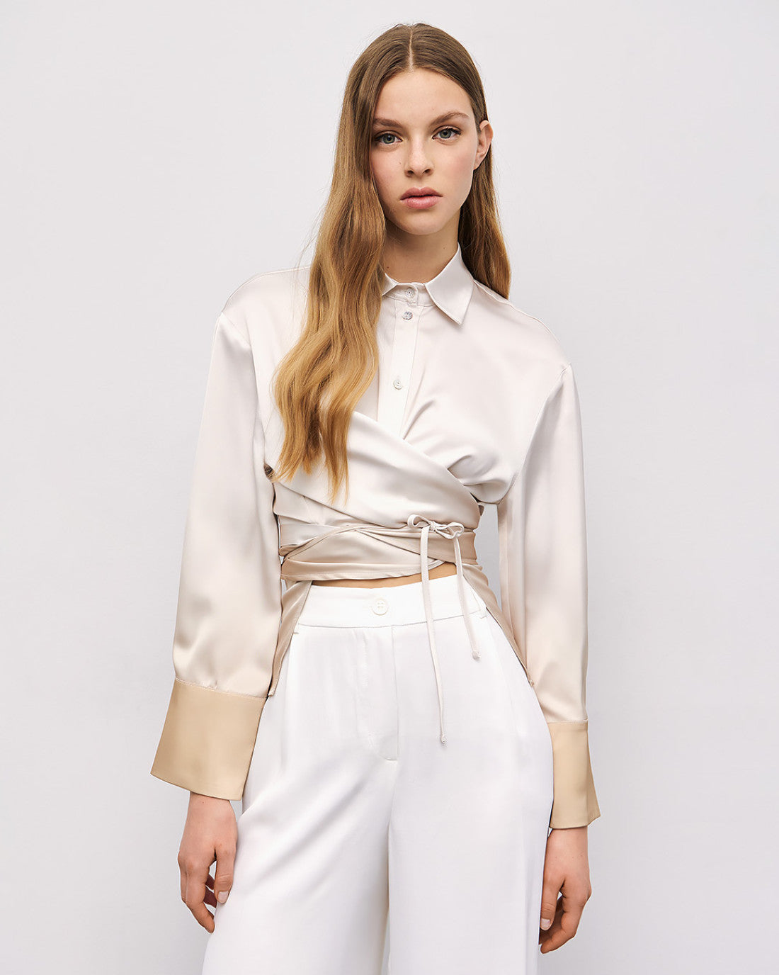 Model wearing Access Fashion cream and gold gradient satin wrap shirt with tie waist