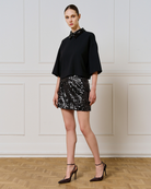 Access Fashion black sequin collar top styled with black sequin mini skirt and heels, full outfit.