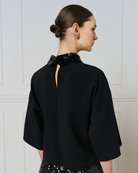 Access Fashion black top back view showing keyhole opening and detachable sequin collar.