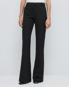Access Fashion high waisted black flared trousers styled with white top.