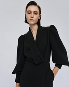 Access Fashion Black Puff Sleeve Jumpsuit close up of wrap neckline and dramatic puff sleeves.