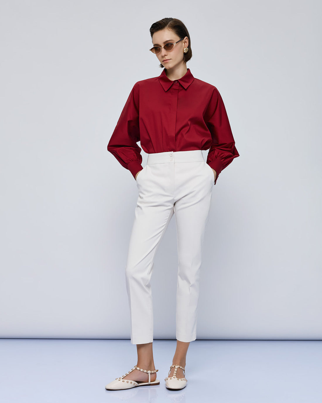 Full-length view of red Access Fashion shirt styled with white trousers