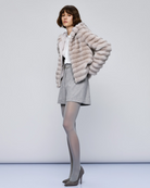 Access Fashion grey faux fur hooded jacket styled with grey shorts – side angle.