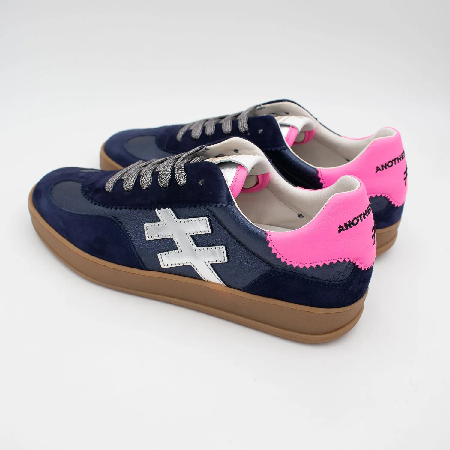 Close-up of metallic pink heel on Another Trend navy suede women’s trainers