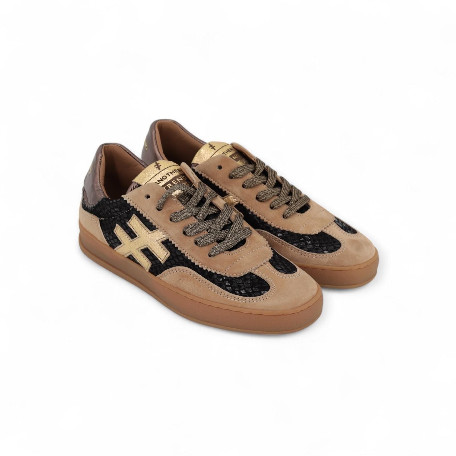 Side view of tan suede trainers with bronze heel and rubber sole