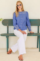 Aspiga blue embroidered shirt full length front With white jeans  