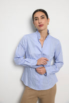 Bariloche Adrano blue pinstripe ruffle collar shirt front view on woman