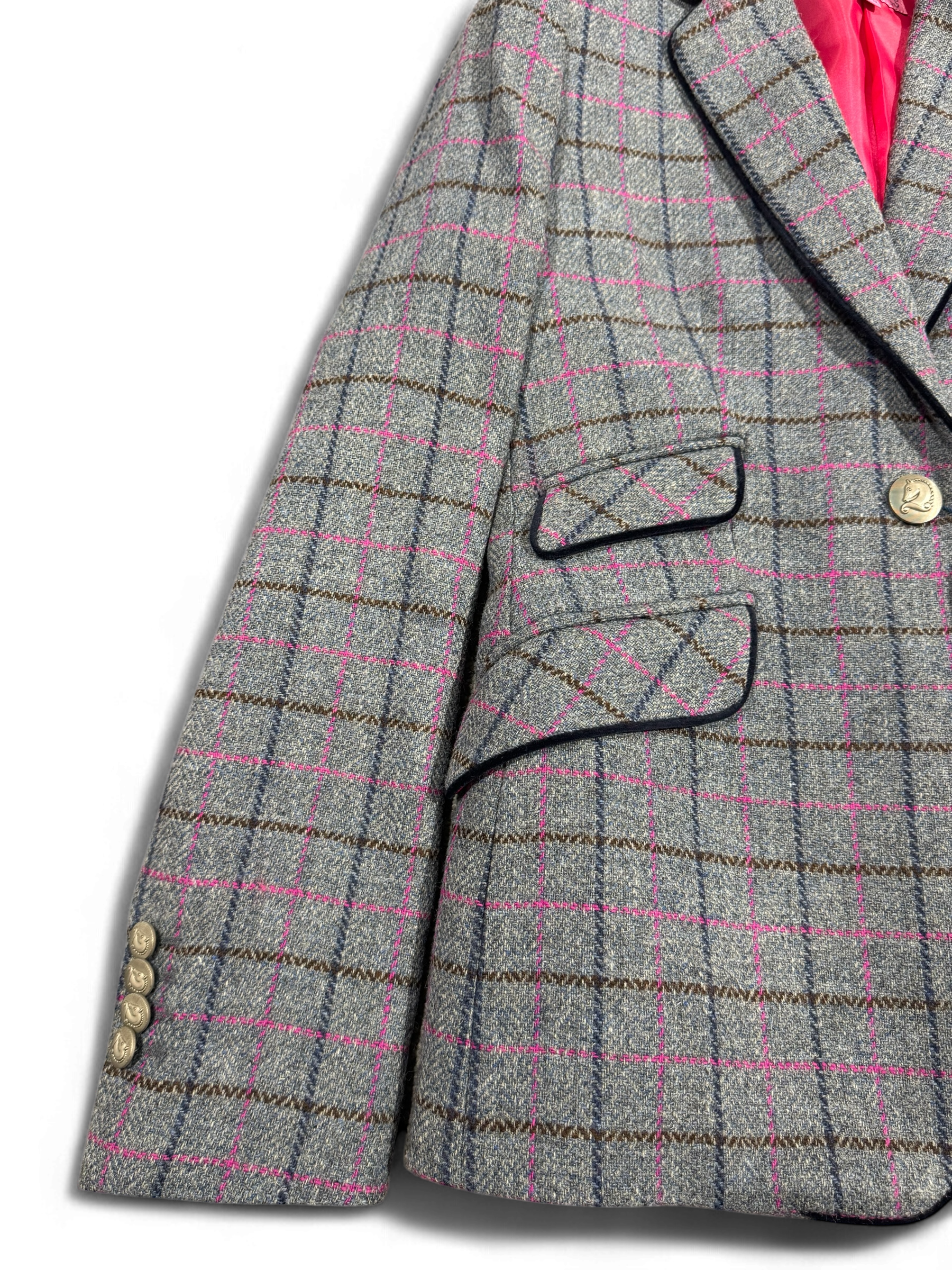 Close-up of Bariloche grey check blazer with pink accents and flap pockets