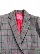 Notch lapel and front pocket detail on grey and pink check Bariloche blazer