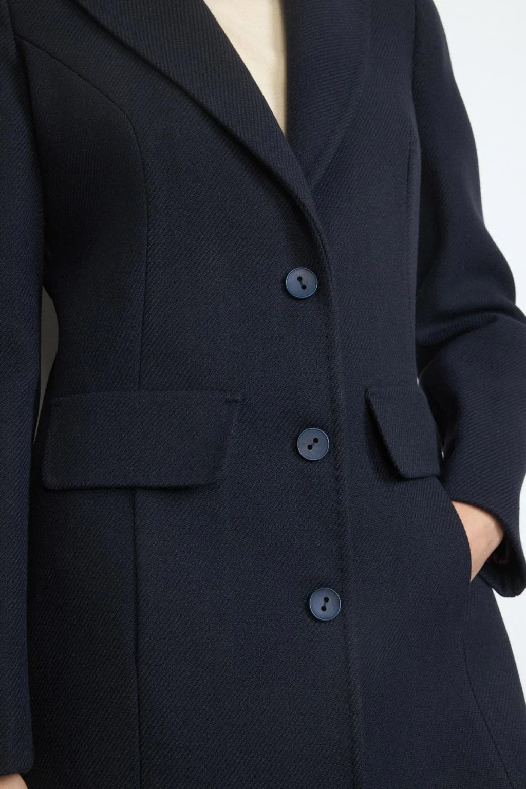 Side profile of Bariloche Cobijo navy women’s overcoat With pockets 