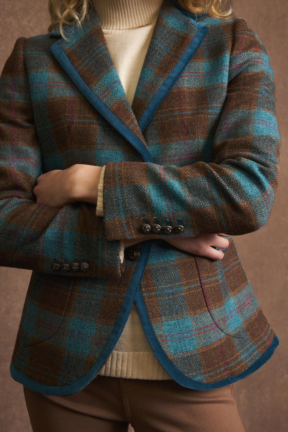 Detail shot showing velvet-trimmed pockets and metal buttons on Bariloche Etrusca blazer