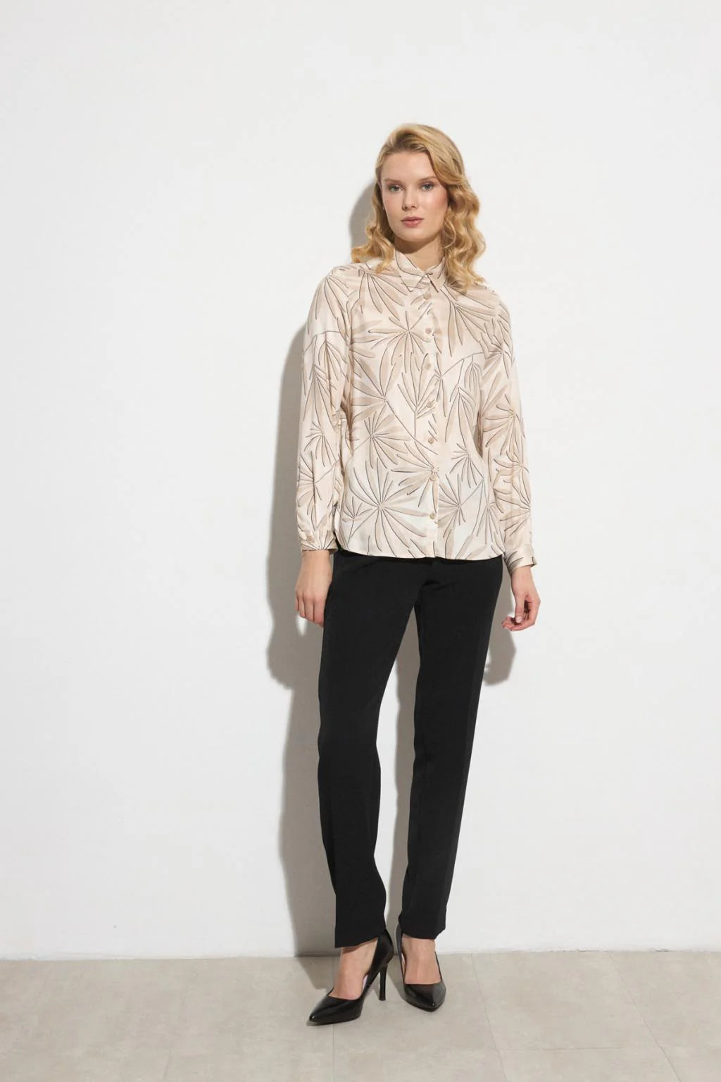 Front view of Bariloche Luncaria black tailored trousers with metallic stud trim.