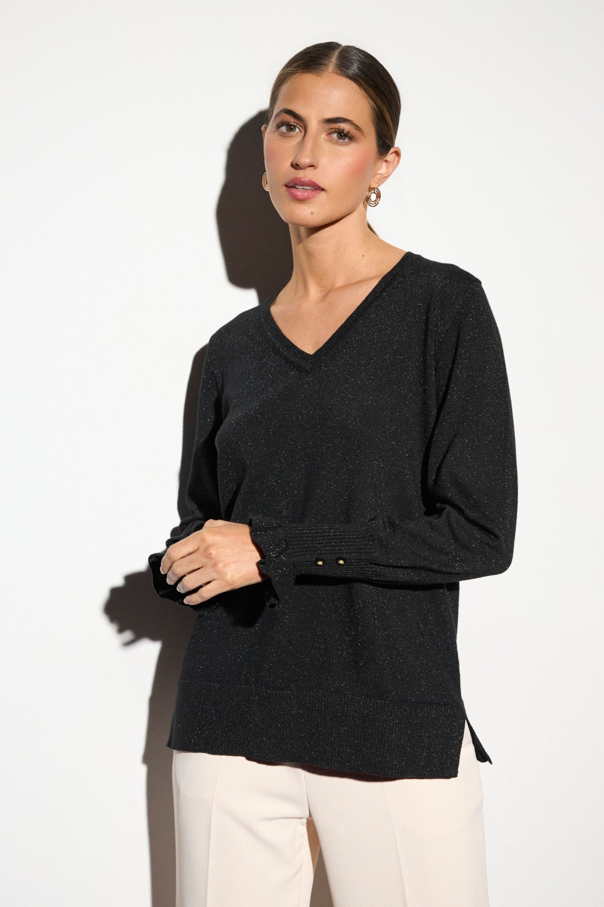  Bariloche Napoli black lurex V-neck jumper – front model view showing frilled button cuffs