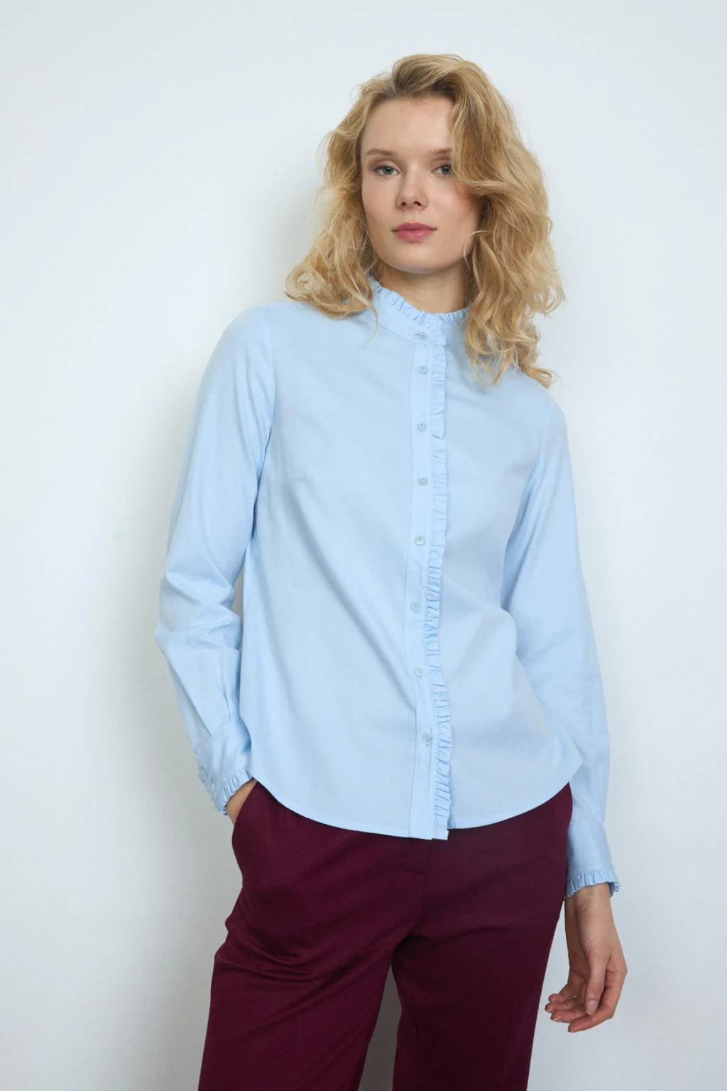 Bariloche Vareia blue ruffled blouse styled with burgundy trousers