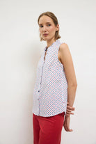 Bariloche printed blouse styled with red trousers
