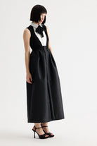 Side view of Birelin Couture black bow neck formal midi dress