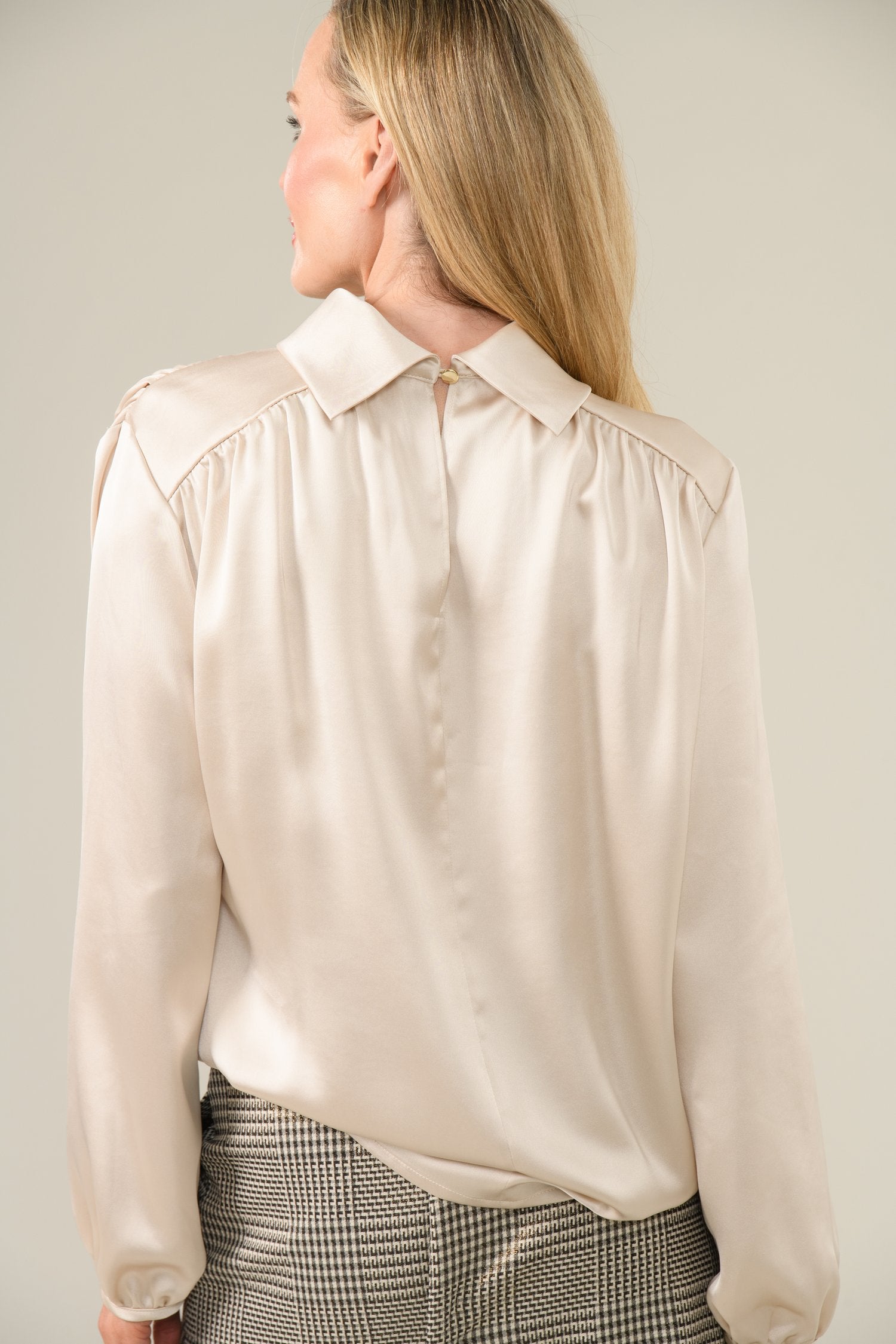 Back view showing concealed zip and soft drape of Gwyneth cream blouse