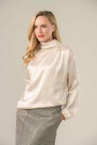 Model wearing Caroline Kilkenny Gwyneth silky cream golden shimmer blouse front view