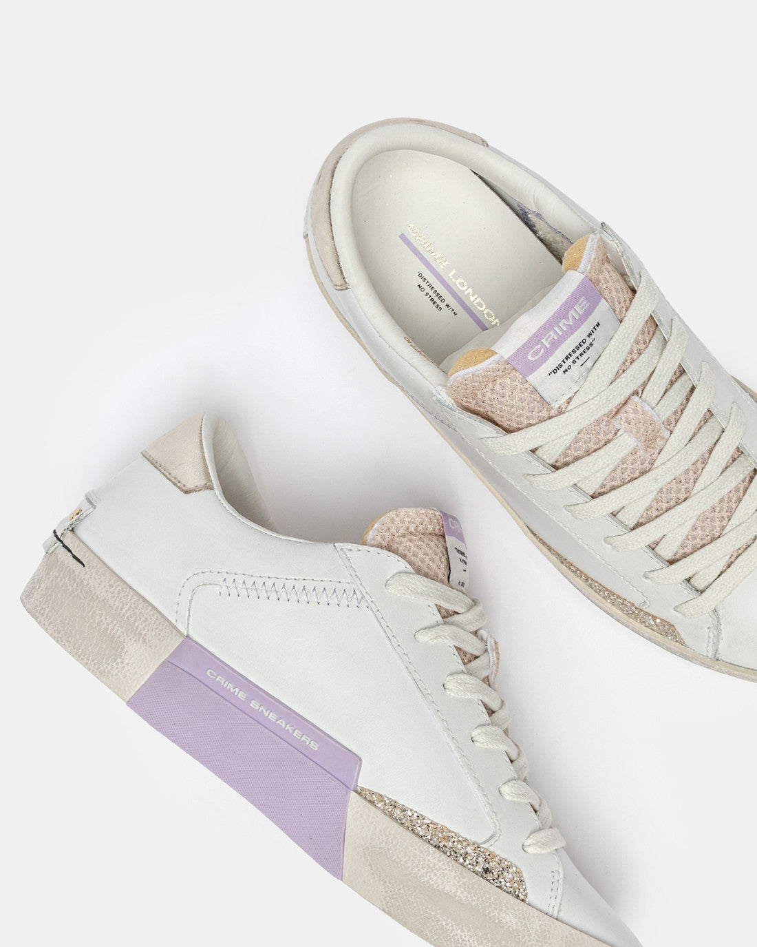 Crime London white leather distressed trainers angled view
