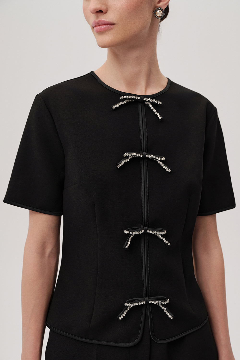 Exquise Black Dove Blouse – close-up showing encrusted bow detailing