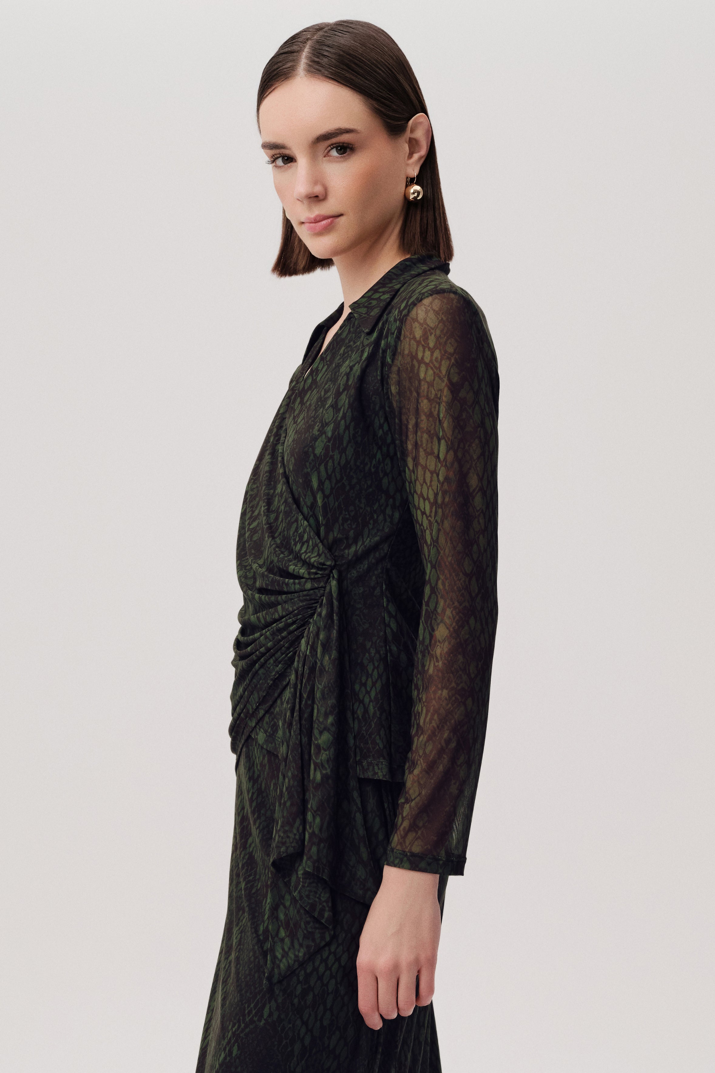 Side angle of Exquise Kinslee K wrap blouse in green snake print