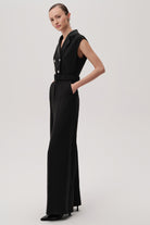 Side profile of Exquise Onyx belted black jumpsuit with wide legs and double-breasted detail
