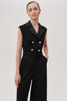 Close-up of satin lapel and embellished button detailing on black Onyx jumpsuit by Exquise.