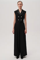 Sleeveless black jumpsuit with satin lapels and crystal buttons by Exquise