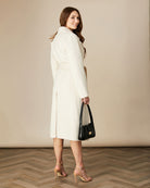 Back view of Fee G Hazel coat in soft cream with fluid drape And split at back