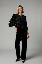 Fee G Jade black velvet occasion jacket styled on model with sequin embellishment