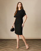Model wearing Fee G Black Harper dress styled with heels