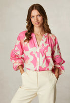 Fee G Daisy pink floral V neck blouse styled with cream trousers