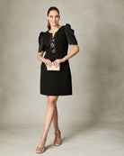 Black evening mini dress with statement bow front embellishment by Fee G