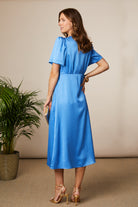 Fee G Jenny blue silky occasion dress back view with wrap silhouette