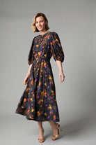 Fee G Kate black floral midi dress shown from a three-quarter angle