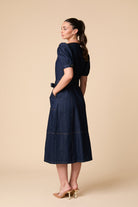 Side view of Fee G Ivy denim shirt dress with pockets
