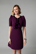 Front view of Fee G Sara plum mini occasion dress with velvet bows