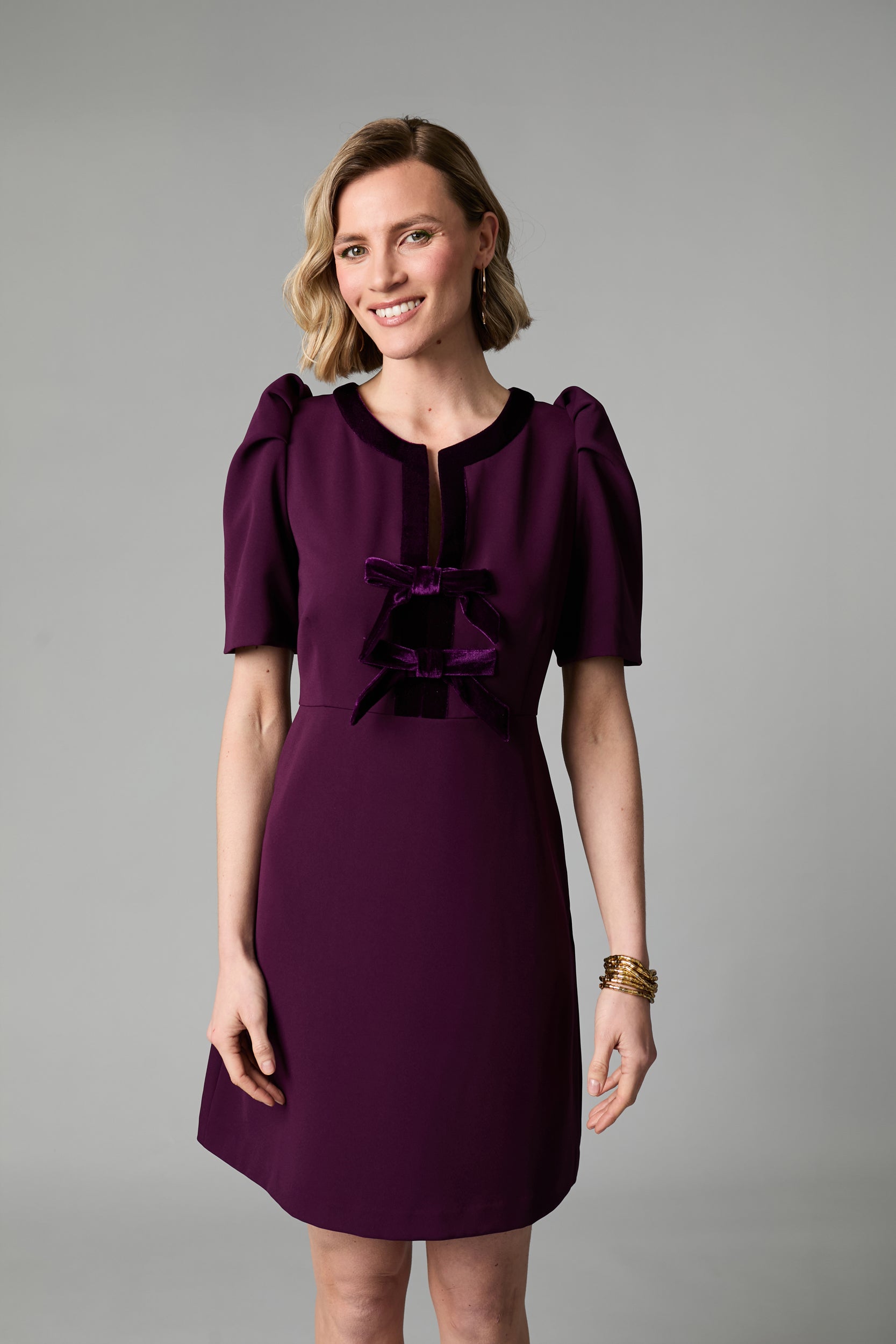 Front view of Fee G Sara plum mini occasion dress with velvet bows