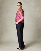 Close-up of FeeG Sophia dressy top with scalloped hem and delicate lace embroidery.