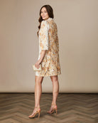 Back view of Fee G Astrid cream puff sleeve beaded mini occasion dress.