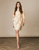 Fee G Astrid cream beaded mini dress with puff sleeves and frilled high neck collar.