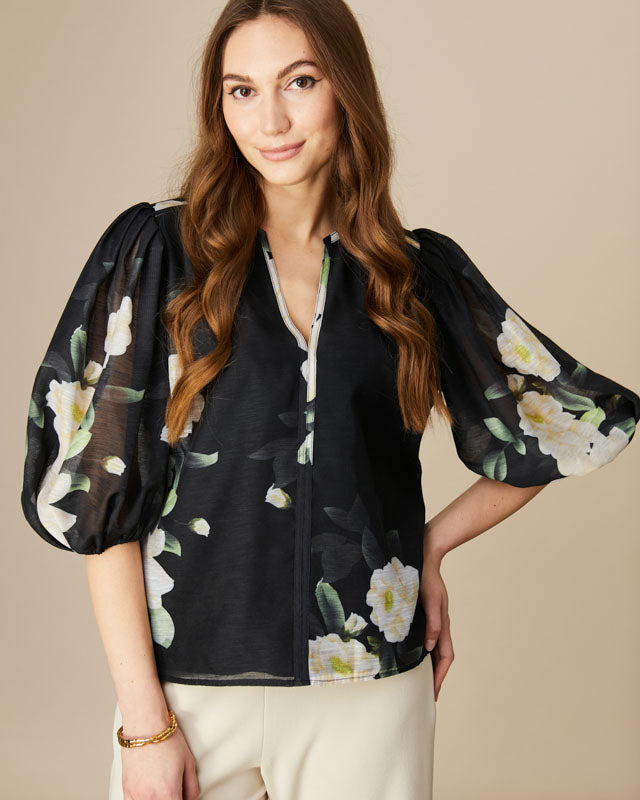 Model wearing Fee G Mila smart blouse styled with tailored trousers.