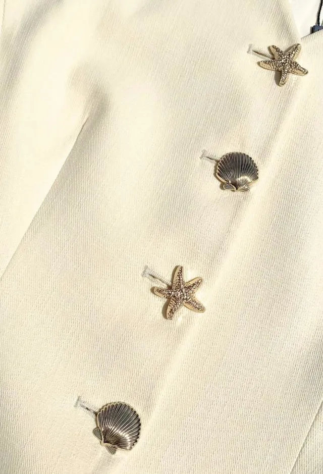 Fee G Jade lemon yellow waistcoat shell button close-up detail